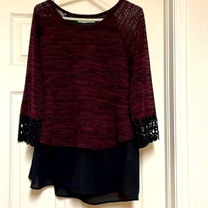 Women’s dark magenta blouse with an attached black undershirt.